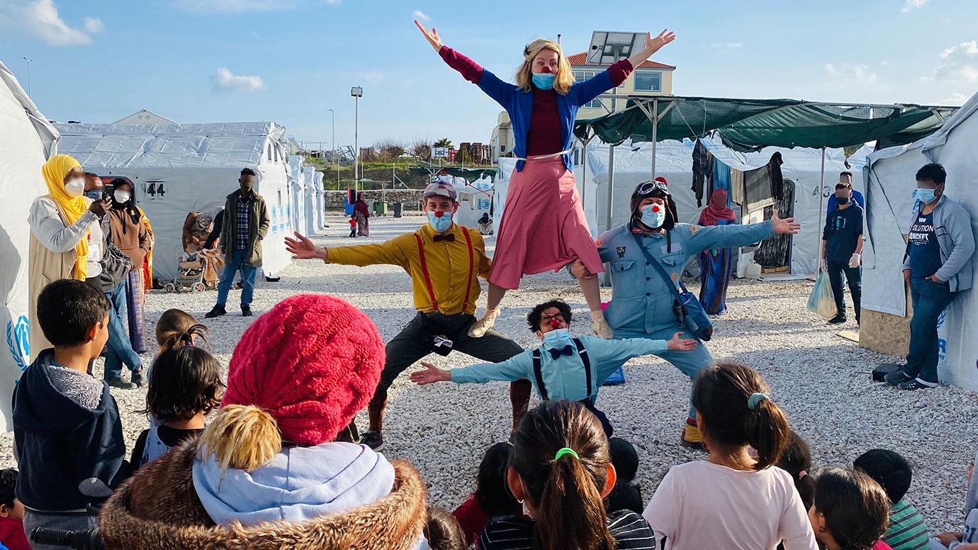 Clown doctors from Red Noses International perform for children in a refugee camp in Lesvos, Greece